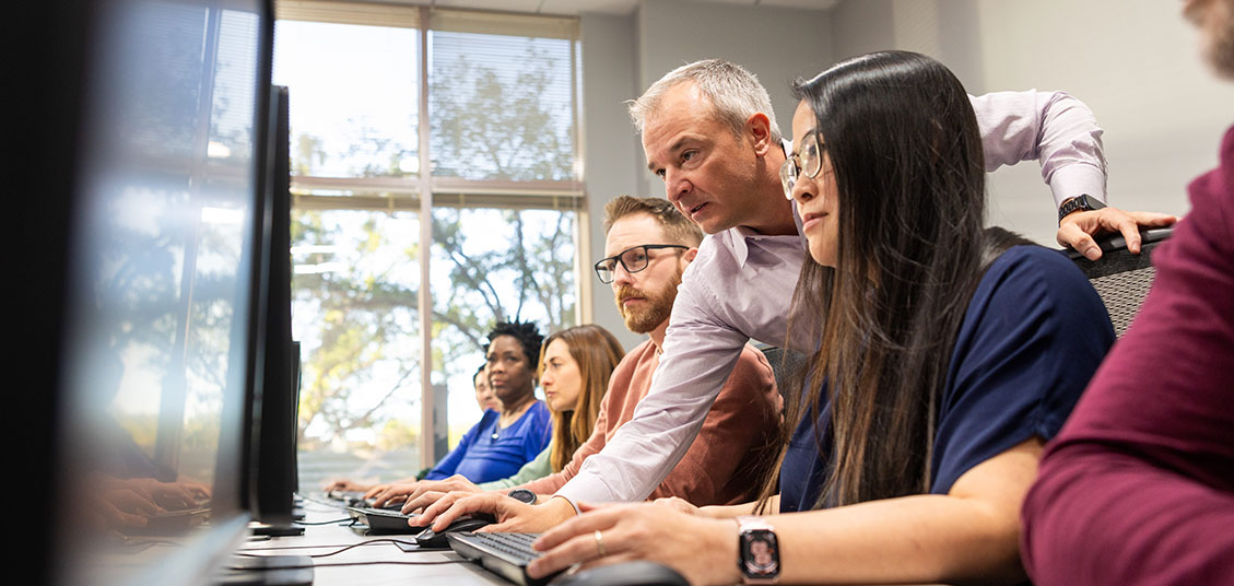 Students working at Trading Academy workstations